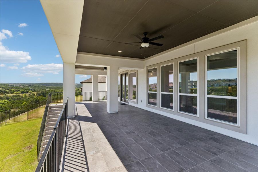 An inviting covered patio offers panoramic views of the surrounding landscape.