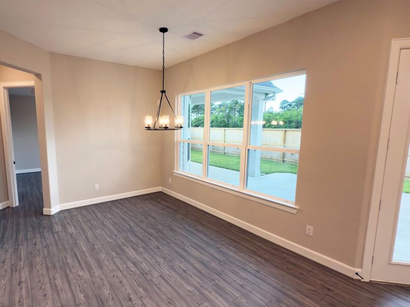 Indulge in elegance where the dining area seamlessly lends sophistication and comfort. With ample space, stunning finishes, and a warm ambiance, it provides intimate dinners and festive gatherings. *Image depicts home as-is. Indulge in elegance where the dining area seamlessly lends sophistication and comfort. With ample space, stunning finishes, and a warm ambiance, it provides intimate dinners and festive gatherings. *Image depicts home as-is.