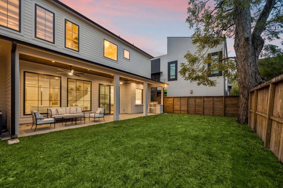 Evening view of the back of the home. The yard has plenty of room for a pool!