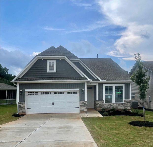 Front exterior of a new home in Springwood Grove, Central, SC, highlighting curb appeal (Image 1). Front exterior of a new home in Springwood Grove, Central, SC, highlighting curb appeal (Image 1).