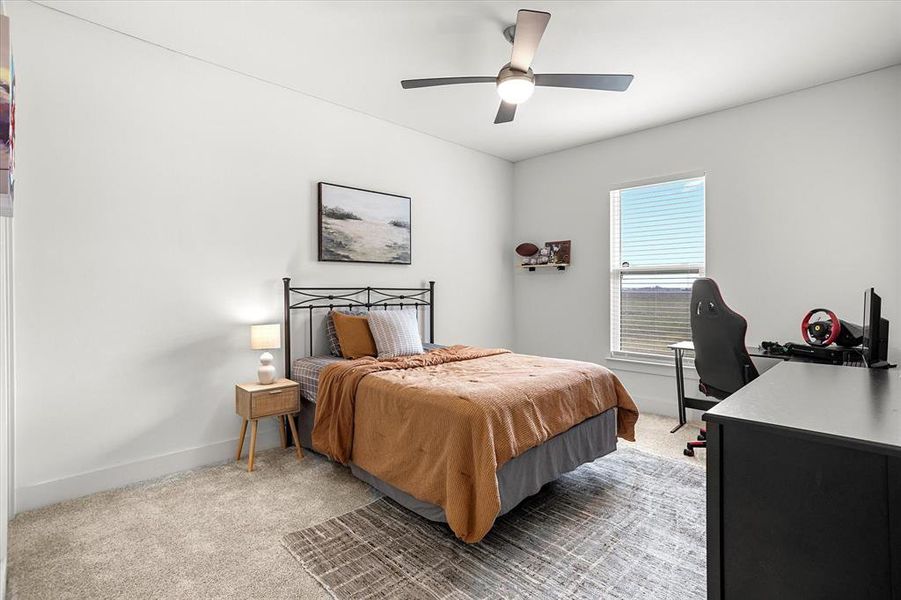 Carpeted bedroom with ceiling fan