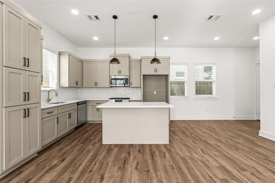 Morning coffee on the quartz island, evening laughs across the open room. This kitchen bridges cooking and living seamlessly, ensuring you never miss a moment of the conversation.