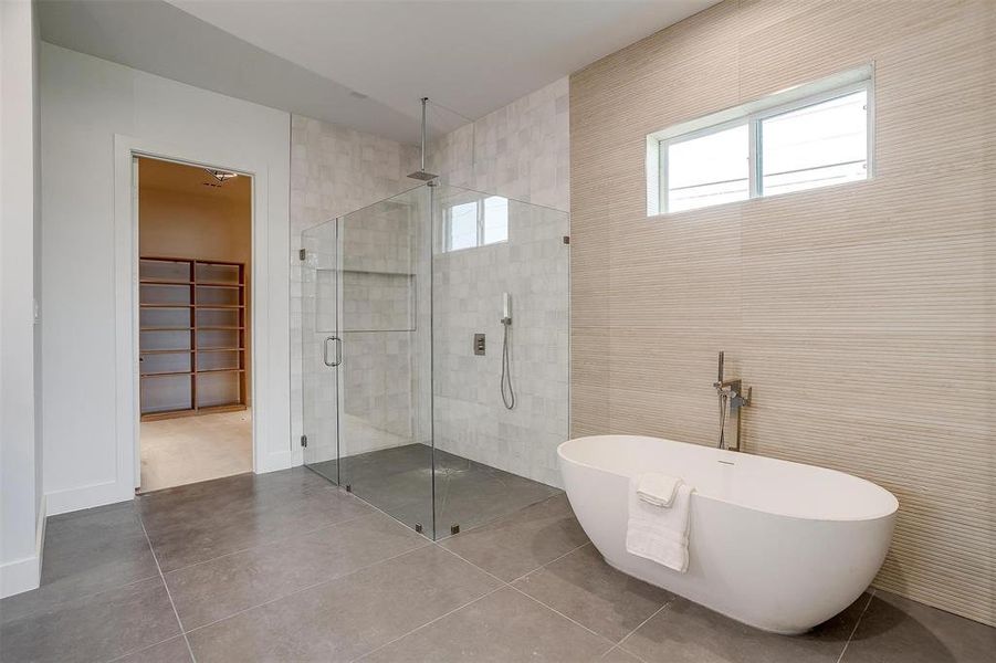 Full bathroom featuring a shower stall, tile walls, and tile patterned floors