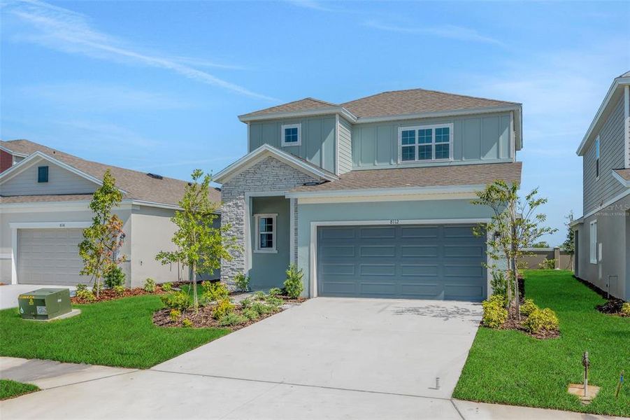 Front exterior of a new home in Seaire, Parrish, FL, highlighting curb appeal (Image 24).