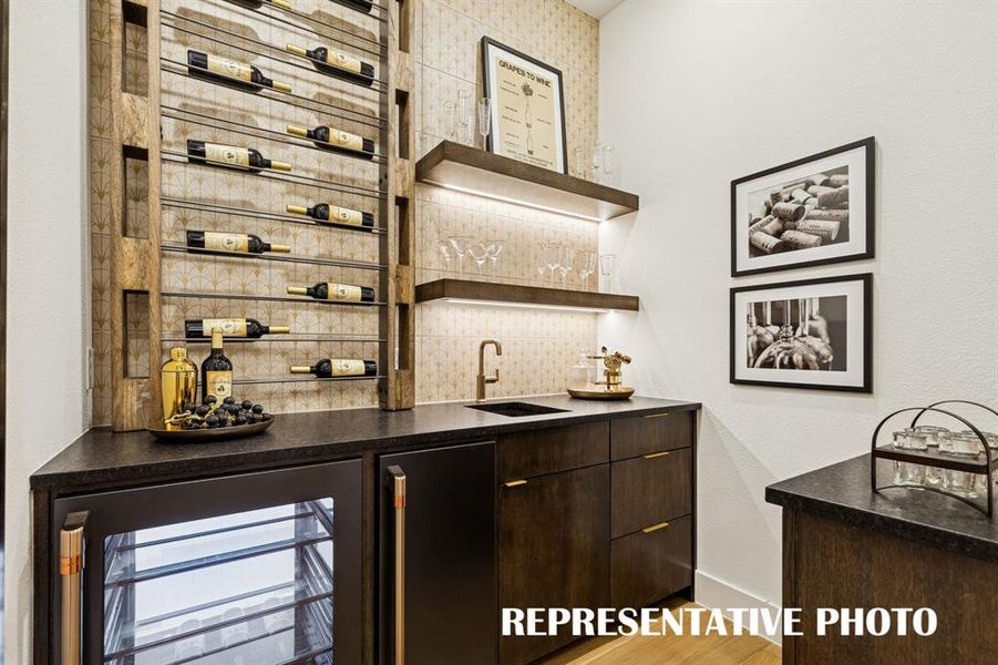 The wet bar, located across the hall from the media room, offers the perfect place for movie drinks and snacks!  REPRESENTATIVE PHOTO