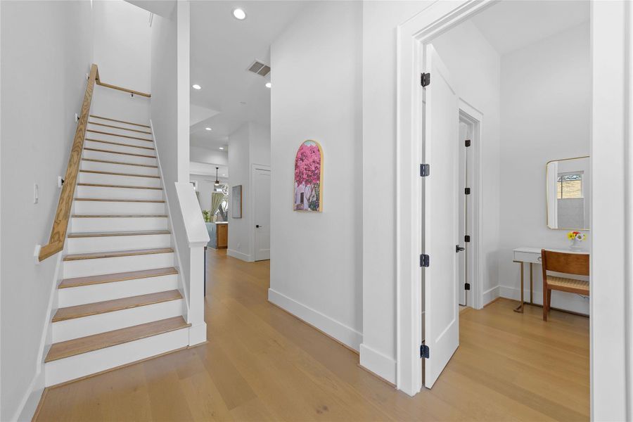 This airy hallway sets the tone with clean lines, tall ceilings, and warm flooring—leading you effortlessly into the heart of the home with a peek at the stunning Hill Country views beyond This airy hallway sets the tone with clean lines, tall ceilings, and warm flooring—leading you effortlessly into the heart of the home with a peek at the stunning Hill Country views beyond