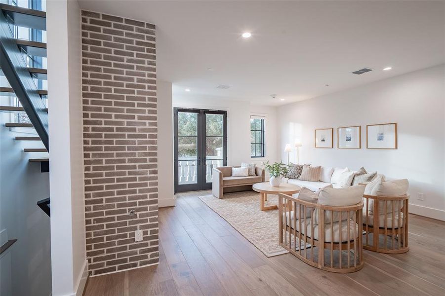 Living room with light hardwood / wood-style floors and french doors