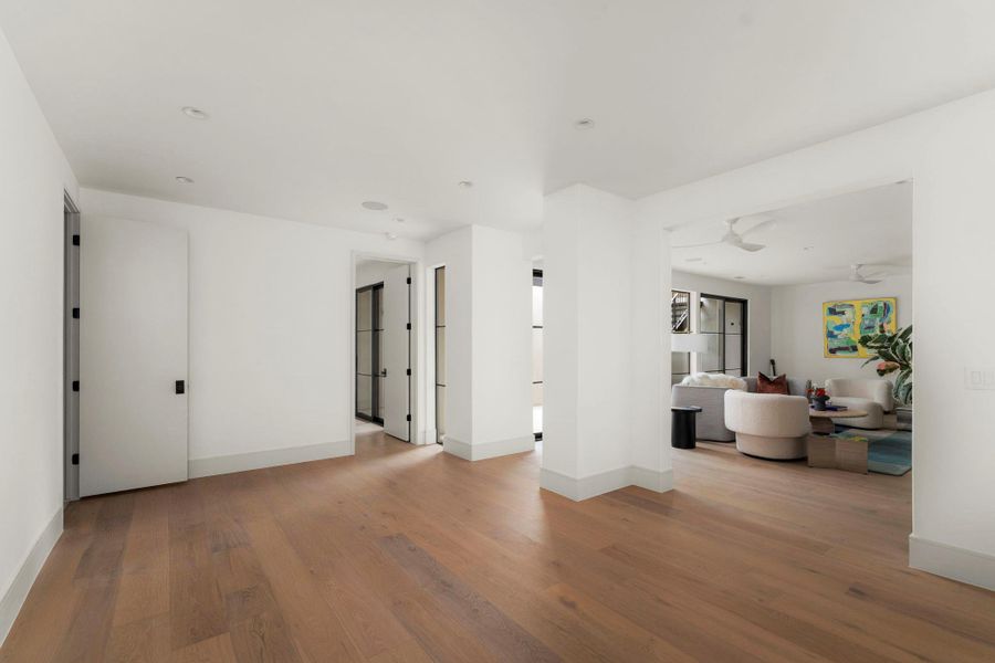 Living area featuring light wood-style floors and ceiling fan