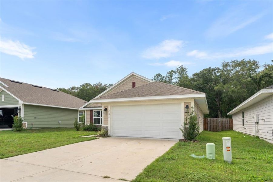 Front exterior of a new home in Savannah Station, Alachua, FL, highlighting curb appeal (Image 2). Front exterior of a new home in Savannah Station, Alachua, FL, highlighting curb appeal (Image 2).