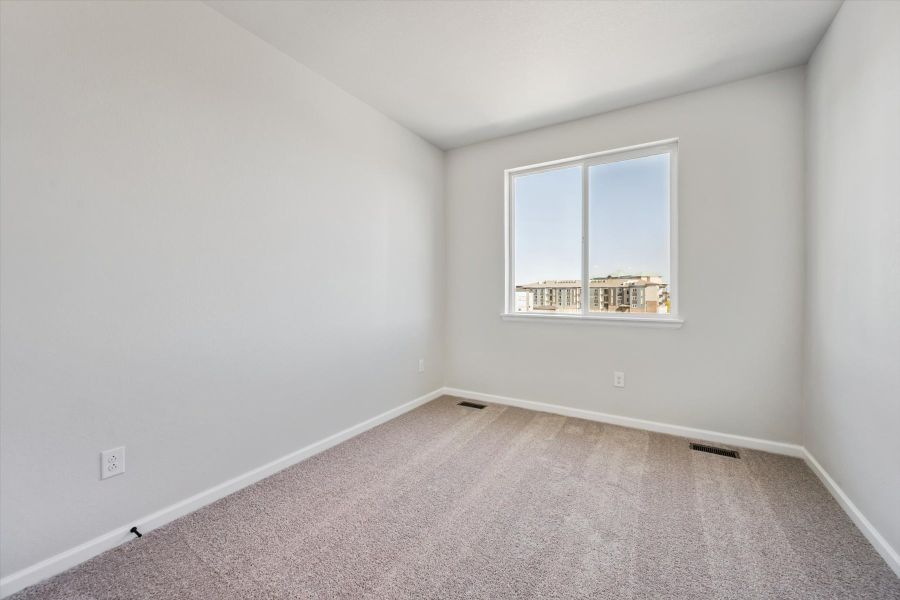 A room with a window and a carpet. A room with a window and a carpet.