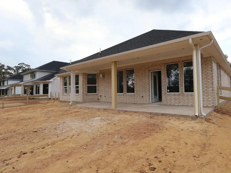 Exterior details and patio area of a home in The Oaks on 6th Street, Magnolia (Image 3).