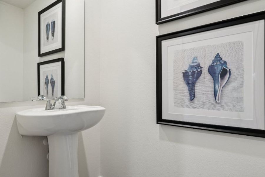 A bathroom with pictures on the wall.