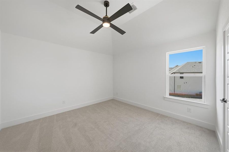 Empty room with light colored carpet and a ceiling fan Empty room with light colored carpet and a ceiling fan