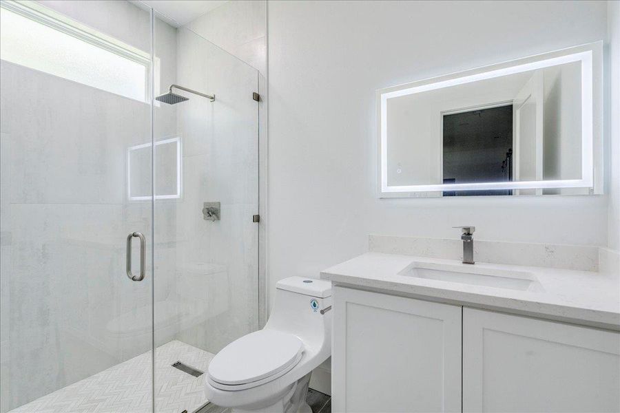 Full Bathroom on the first floor of the garage with easy access to the yard