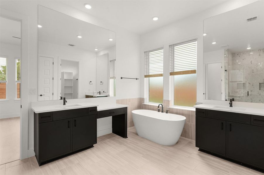 Full bathroom featuring two vanities, a marble finish shower, a freestanding tub, recessed lighting, and a wainscoted wall Full bathroom featuring two vanities, a marble finish shower, a freestanding tub, recessed lighting, and a wainscoted wall