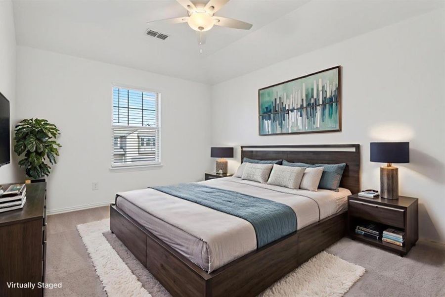 Carpeted bedroom featuring ceiling fan and baseboards