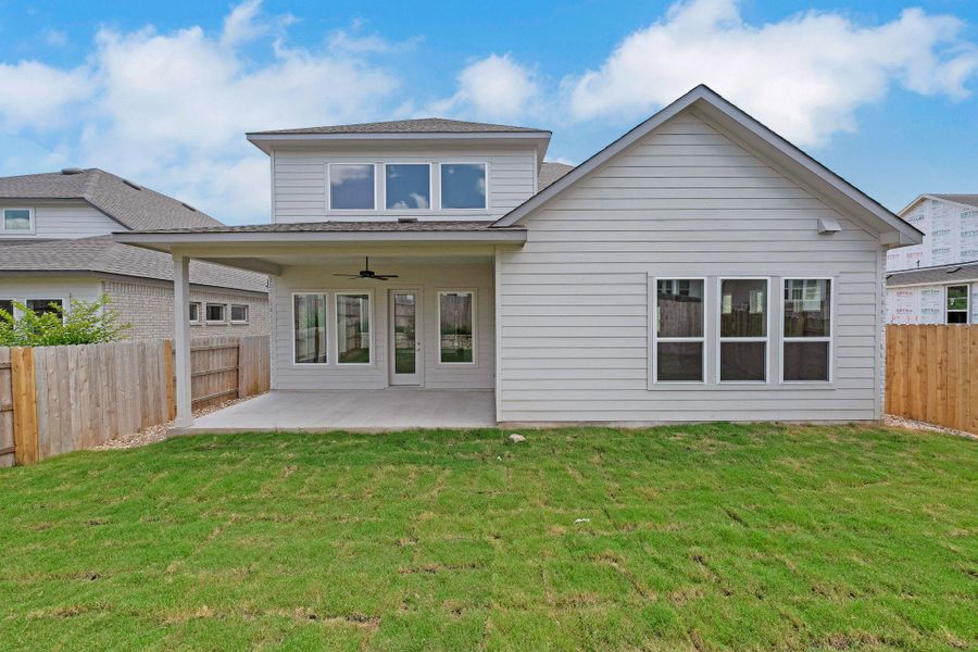 Back of house with a patio, a fenced backyard, and ceiling fan Back of house with a patio, a fenced backyard, and ceiling fan