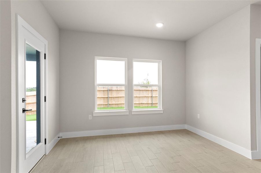 Unfurnished room featuring plenty of natural light, light wood-type flooring, baseboards, and recessed lighting Unfurnished room featuring plenty of natural light, light wood-type flooring, baseboards, and recessed lighting