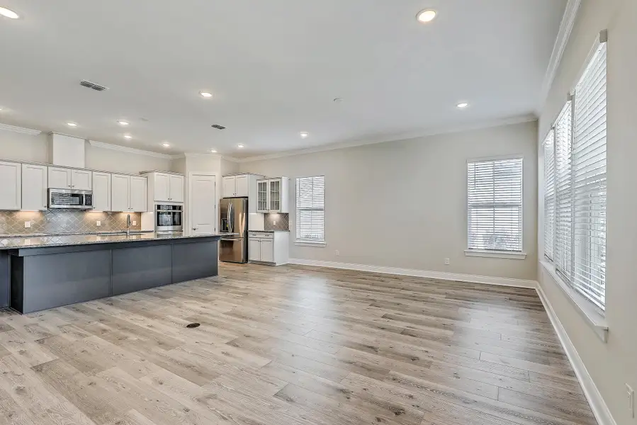 Spacious, unfurnished interior of a new home in K. Hovnanian's® Four Seasons at Lakes of Cane Bay, Summerville (Image 32).