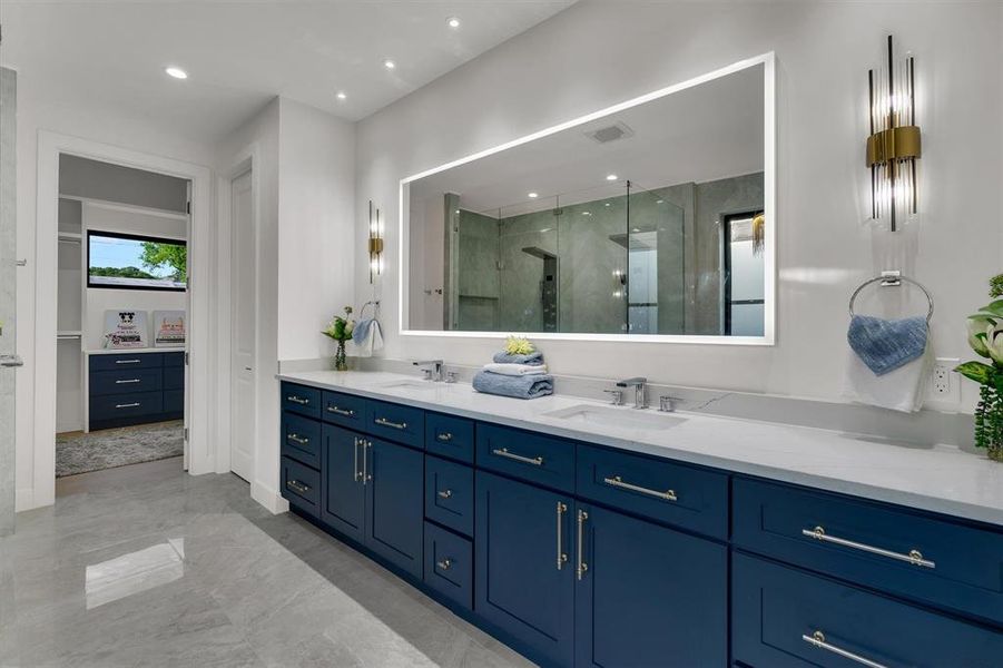 Bathroom featuring vanity and a shower with door