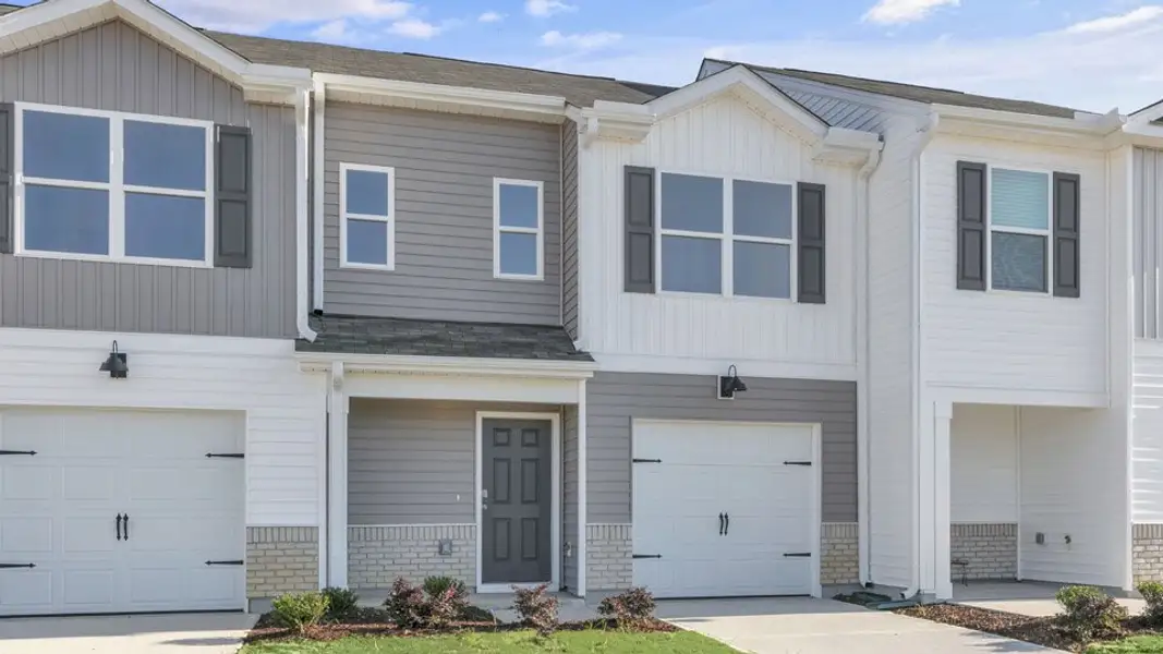 Front exterior of a new home in The Townes at Honeycutt Oaks, Angier, NC, highlighting curb appeal (Image 2). Front exterior of a new home in The Townes at Honeycutt Oaks, Angier, NC, highlighting curb appeal (Image 2).