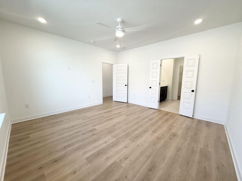 Unfurnished bedroom with recessed lighting, a ceiling fan, light wood finished floors, and ensuite bathroom