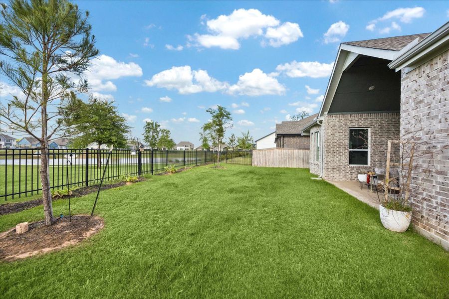 Generous backyard stretches along the water with clean landscaping and plenty of room to play, garden, or add a future pool. Covered patio sits just off the home, creating an easy indoor outdoor flow for everyday living and entertaining. Generous backyard stretches along the water with clean landscaping and plenty of room to play, garden, or add a future pool. Covered patio sits just off the home, creating an easy indoor outdoor flow for everyday living and entertaining.