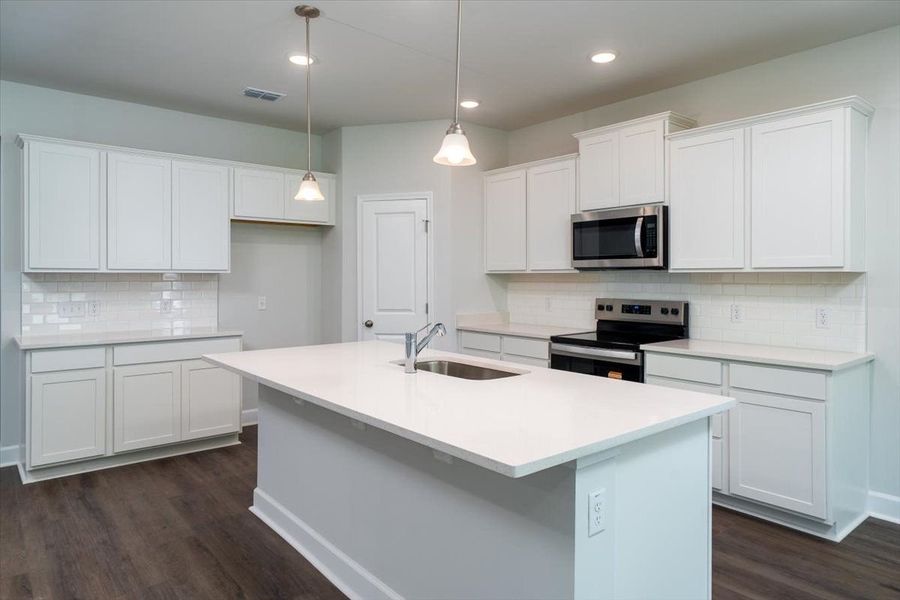 The kitchen offers plenty of cabinet of counter space for meal prep. The kitchen offers plenty of cabinet of counter space for meal prep.