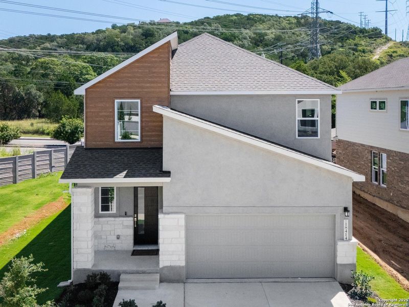 Front exterior of a new home in Crown Ridge Manor, San Antonio, TX, highlighting curb appeal (Image 2).