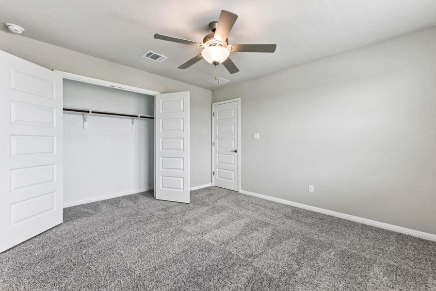 Bedroom #4 upstairs w/ closet & ceiling fan