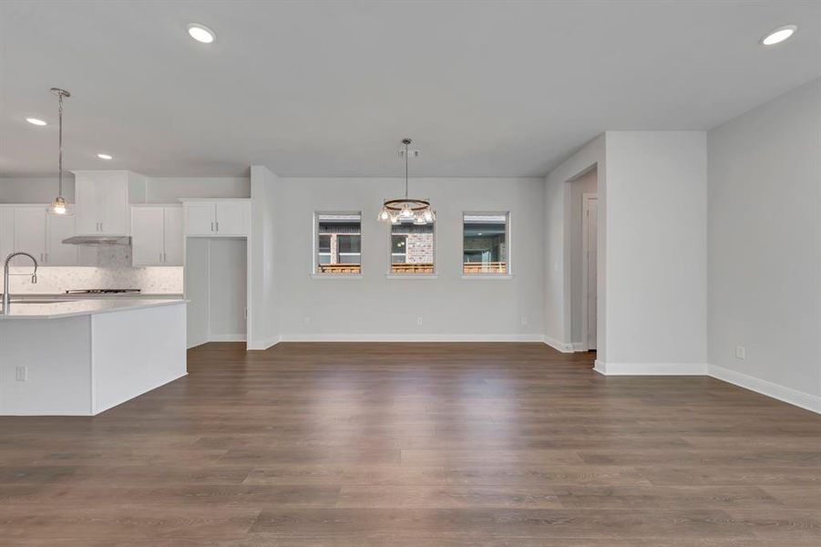 Unfurnished dining area with recessed lighting and dark wood finished floors