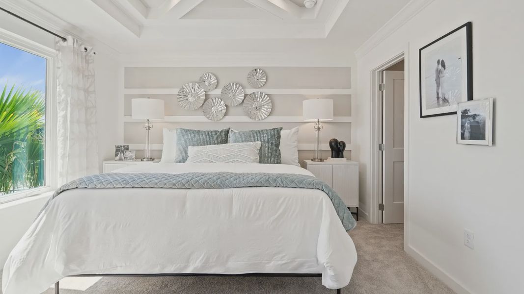 Primary suite with large double window and tray ceiling in a DRB Homes Ambersweet model at the Trinity Place community. Primary suite with large double window and tray ceiling in a DRB Homes Ambersweet model at the Trinity Place community.