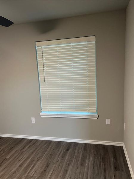 Spare room featuring wood finished floors and baseboards
