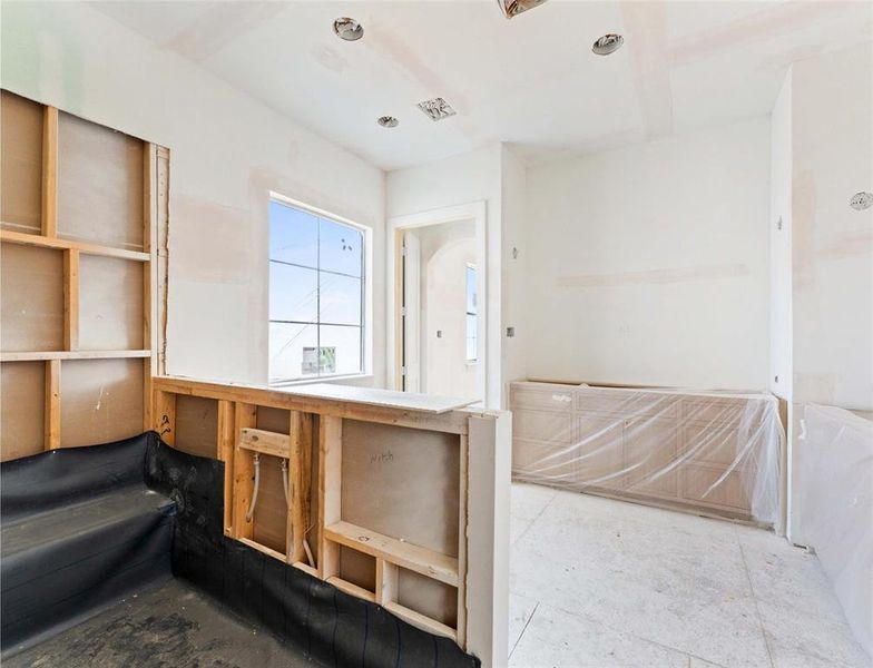 Primary bathroom with dual shower; custom white oak cabinets for vanities will be enhanced by Perla Venata quartzite.