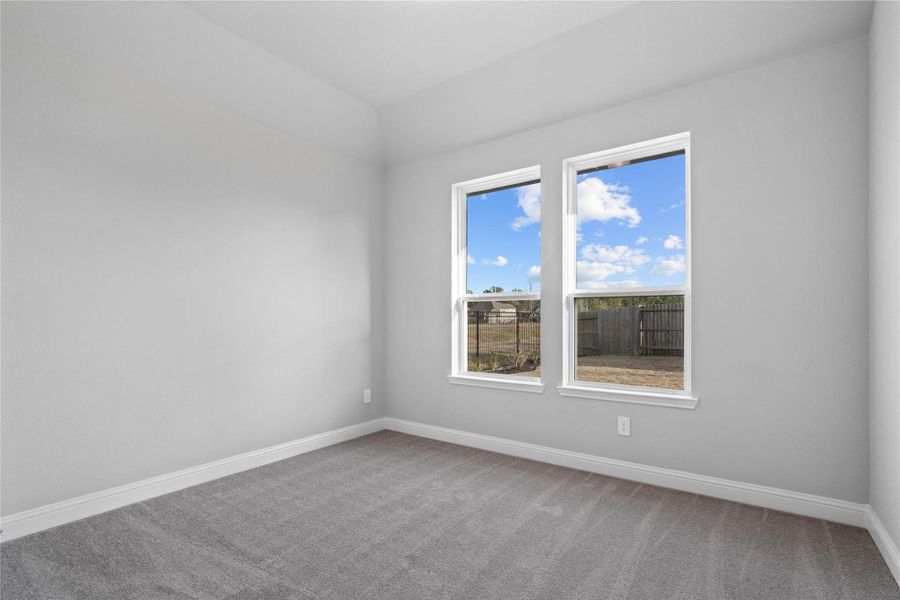 This guest suite, which offers a bright layout with neutral finishes and natural light. Featuring plush carpeting, large windows, and an en-suite secondary bathroom.