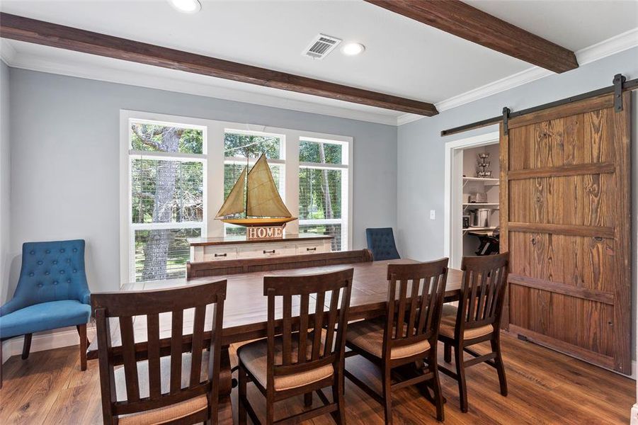 This Dining room is lovely and offers a lot of flexibility in how you might use it. Plus, the barn door shuts off the extra storage area and laundry space.