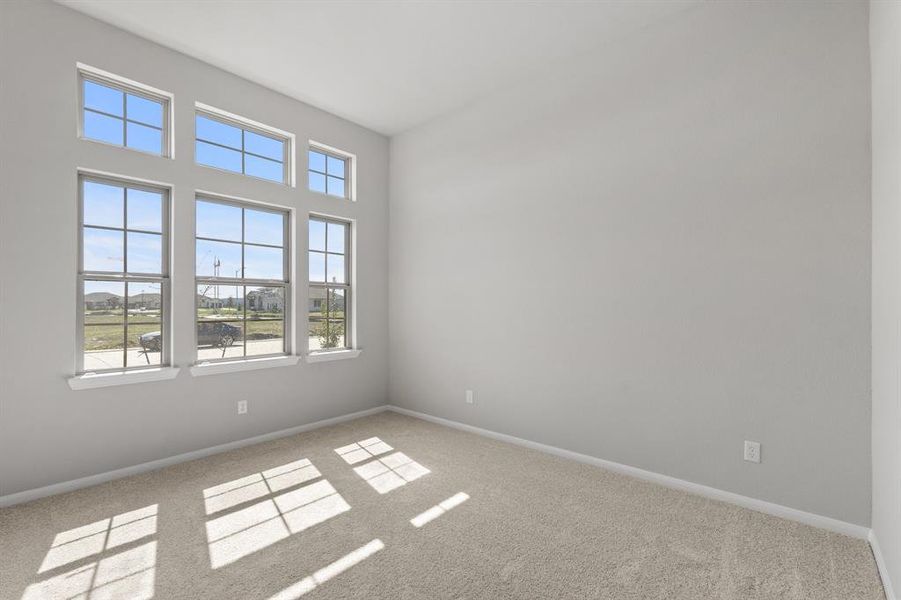 Your secondary bedroom features plush carpet, fresh paint, closet, and a large window that lets in plenty of natural lighting.