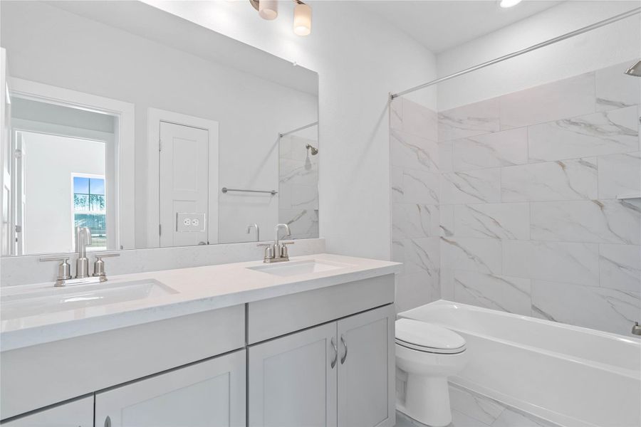 Maximize functionality and reduce morning congestion with this bright secondary bathroom, featuring an invaluable dual vanity sink setup that every family will appreciate. The practical combination of a shower and tub is ideal for both quick showers and relaxing baths for children or guests. Maximize functionality and reduce morning congestion with this bright secondary bathroom, featuring an invaluable dual vanity sink setup that every family will appreciate. The practical combination of a shower and tub is ideal for both quick showers and relaxing baths for children or guests.