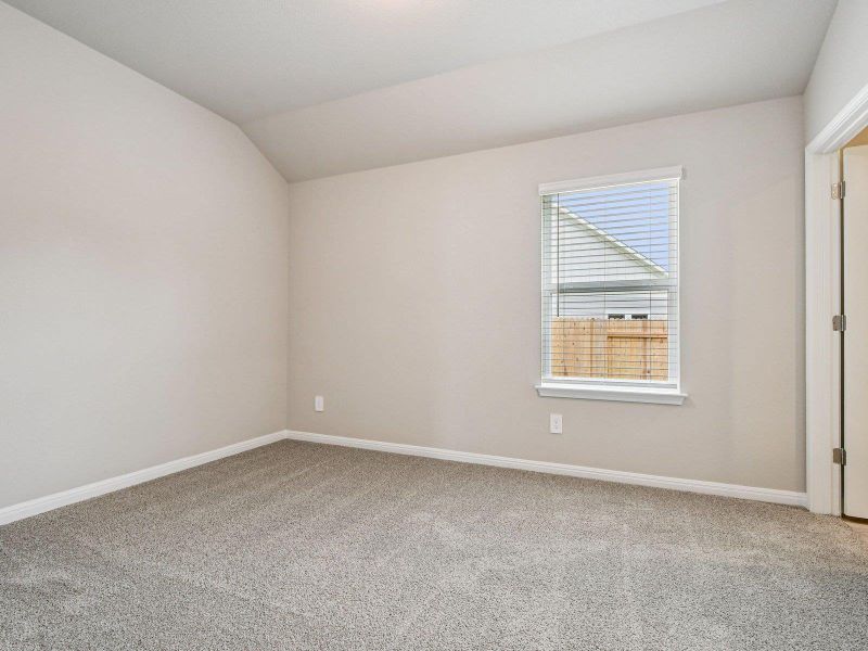 Spare room featuring carpet flooring and vaulted ceiling Spare room featuring carpet flooring and vaulted ceiling