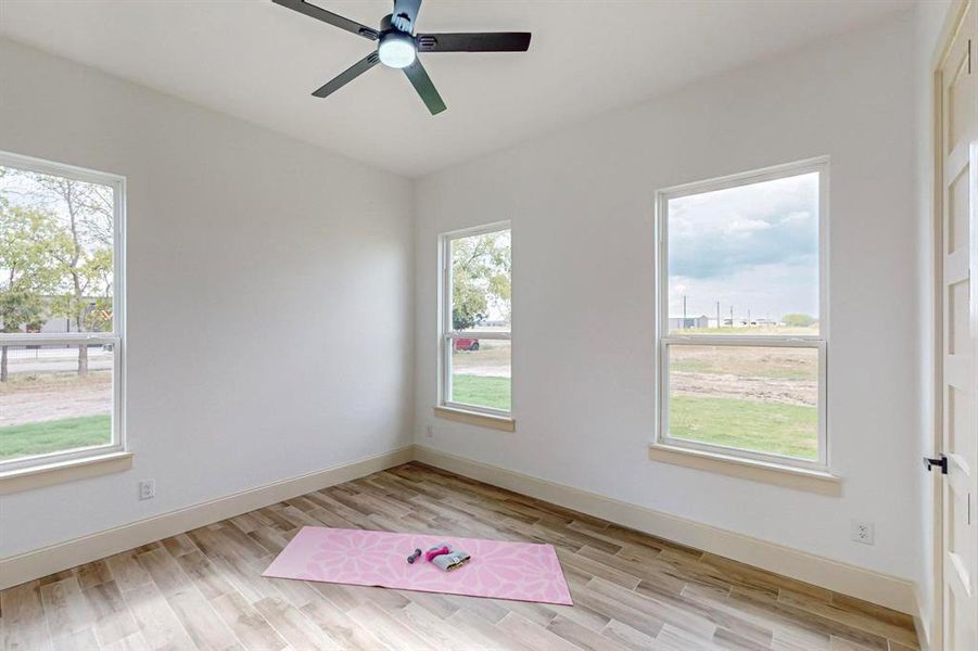 Spare room featuring ceiling fan and light hardwood / wood-style floors