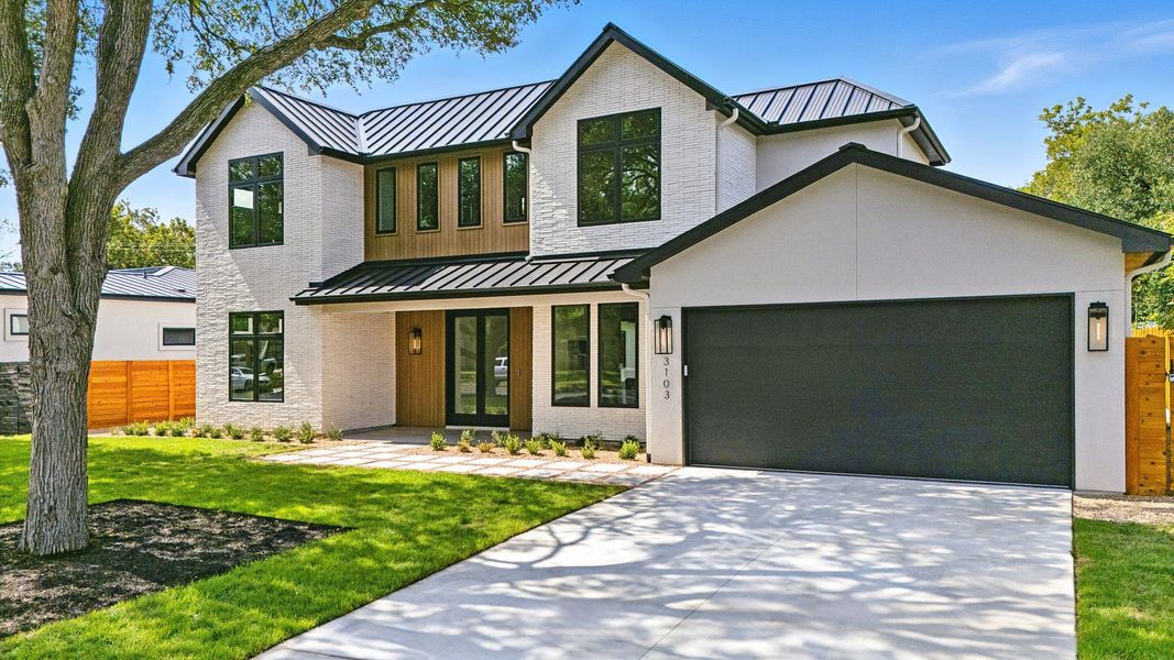View of front of property featuring a standing seam roof, a metal roof, and brick siding View of front of property featuring a standing seam roof, a metal roof, and brick siding