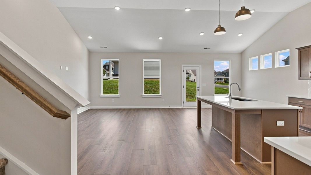 Open concept first floor with kitchen, dining, and living room areas