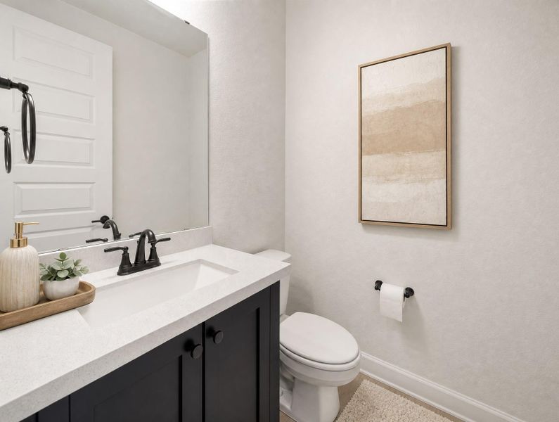 A well-appointed guest bath featuring a dark vanity, light countertops, and clean fixtures. A well-appointed guest bath featuring a dark vanity, light countertops, and clean fixtures.