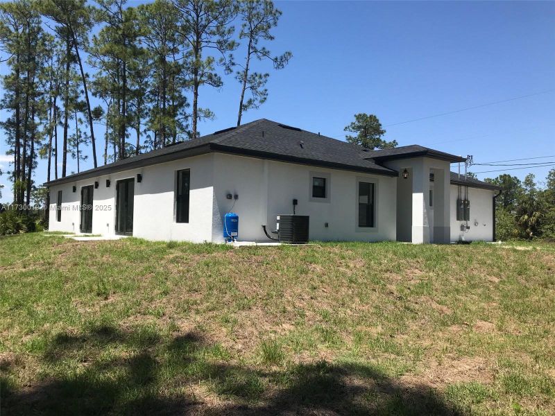 Front exterior of a new home in , Lehigh Acres, FL, highlighting curb appeal (Image 2).