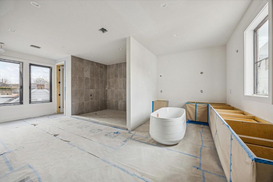 Primary bathroom features custom cabinetry, his and her water closets, and a large wet room. Primary bathroom features custom cabinetry, his and her water closets, and a large wet room.