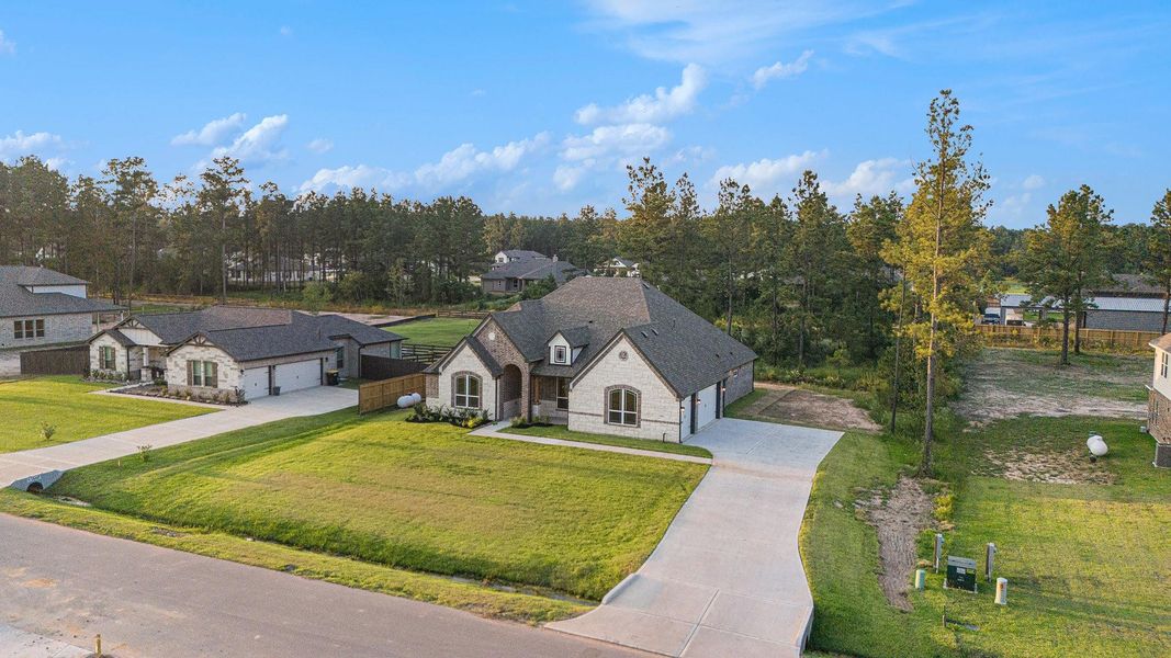 Front exterior of a new home in Deer Pines, Conroe, TX, highlighting curb appeal (Image 22). Front exterior of a new home in Deer Pines, Conroe, TX, highlighting curb appeal (Image 22).