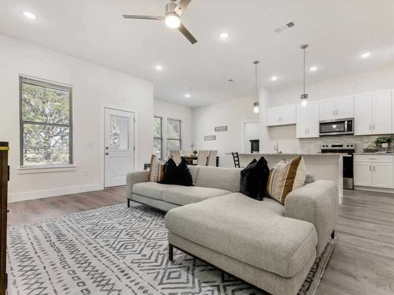 Living area featuring recessed lighting, light wood finished floors, and ceiling fan