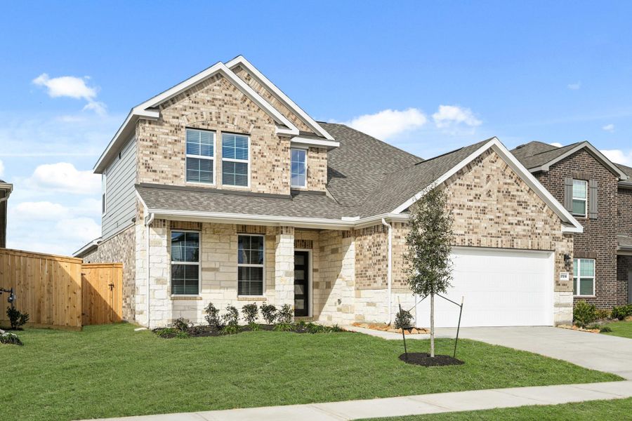 Front exterior of a new home in Sunterra, Katy, TX, highlighting curb appeal (Image 20).