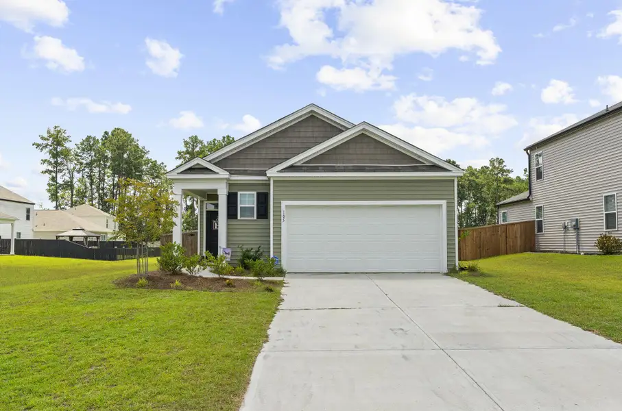 Front exterior of a new home in Pine Hills at Cane Bay, Summerville, SC, highlighting curb appeal (Image 23).