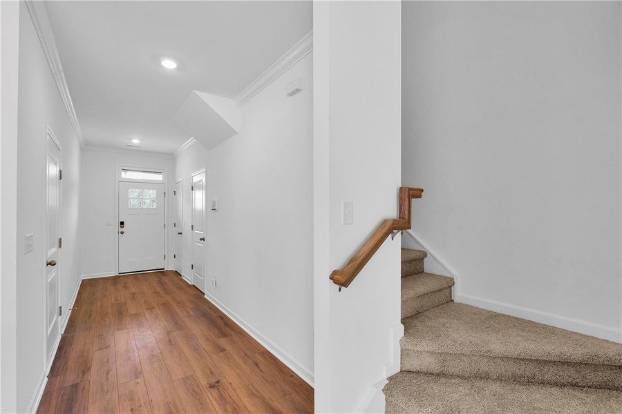 This bright entry welcomes you with rich flooring